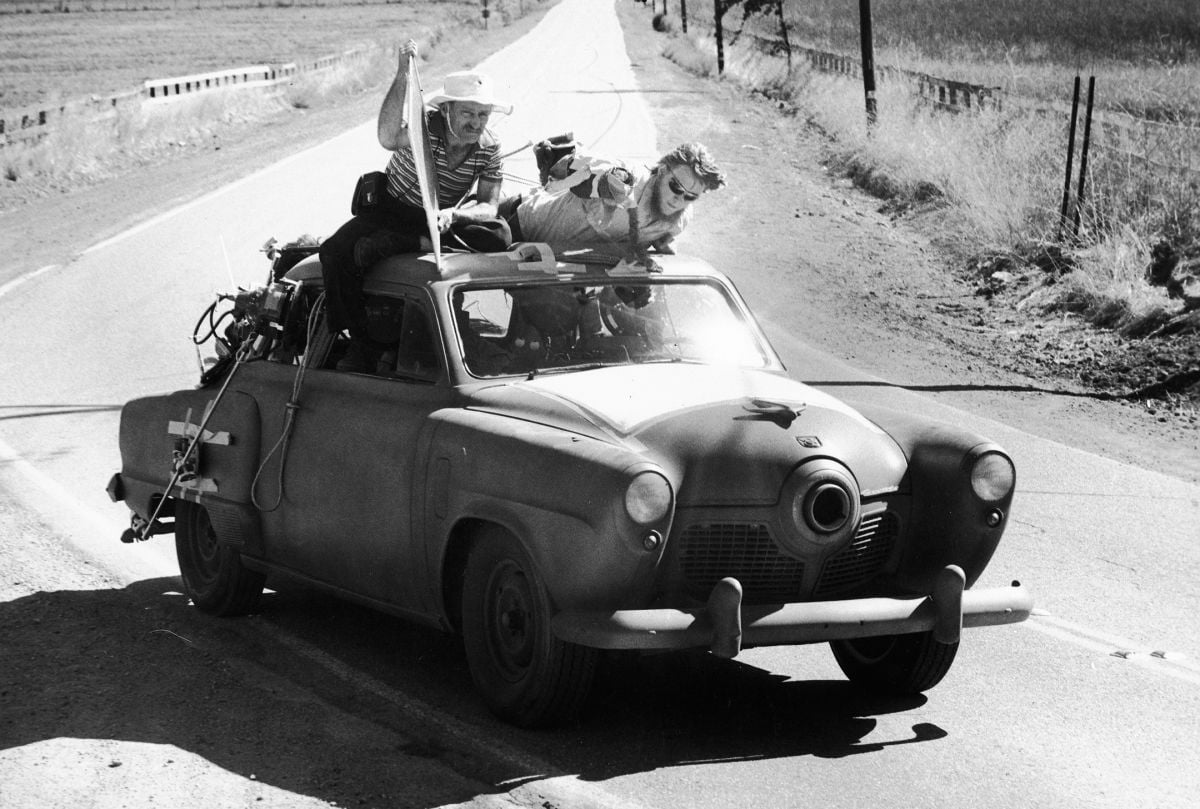 Shooting The Muppet Movie (1979): Holding a flag, Mankofsky helps shape his lighting on "Gonzo the Great" from the top of a Studebaker. The camera is in the back seat, facing the windshield.